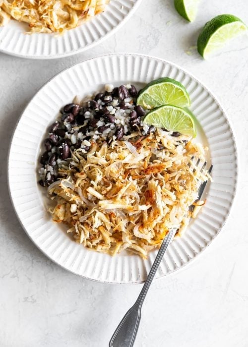 cuban shredded chicken with black beans and rice on a white plate