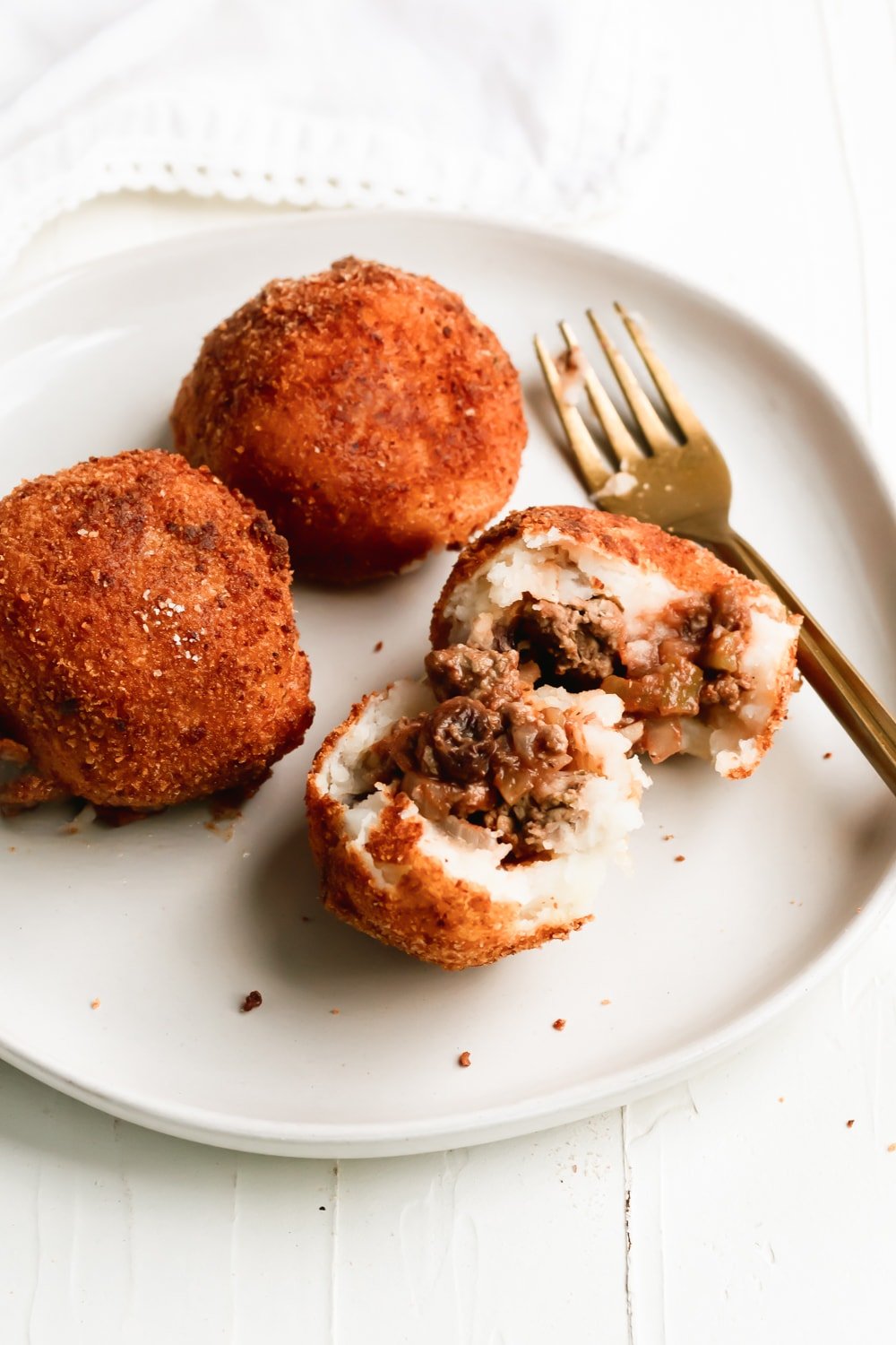 papas rellenas showing the picadillo filling on a white plate