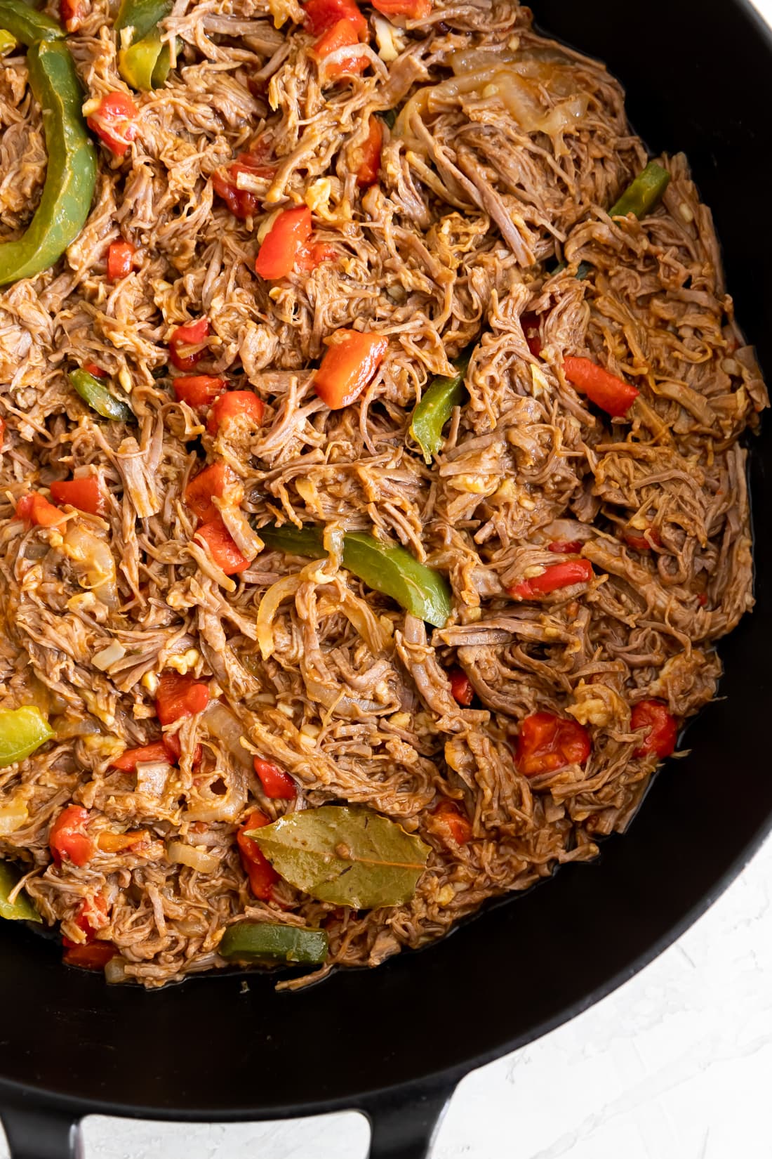 cooked Cuban ropa vieja with sofrito in a braiser