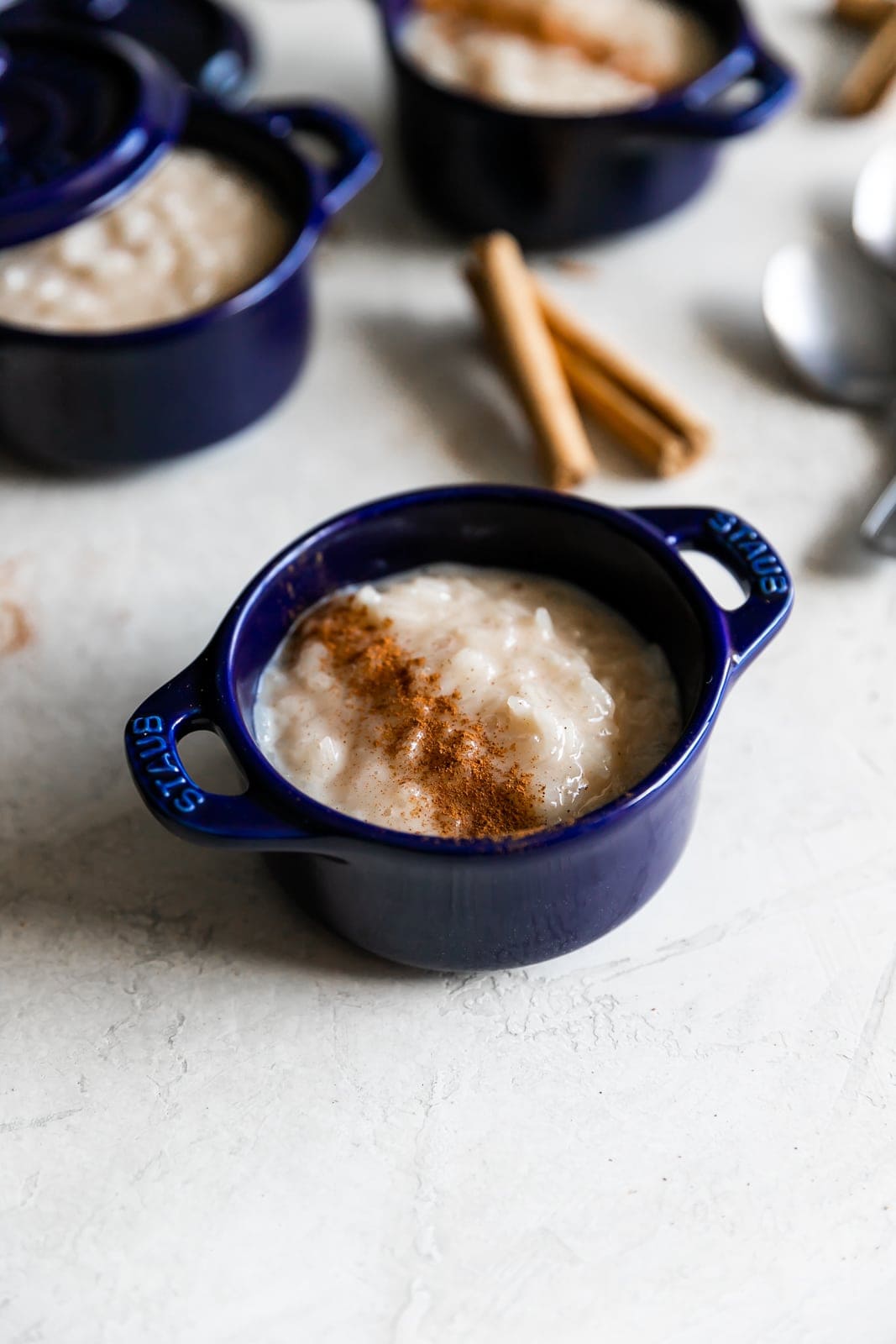 sweet rice pudding with cinnamon sprinkled on top in ramekins