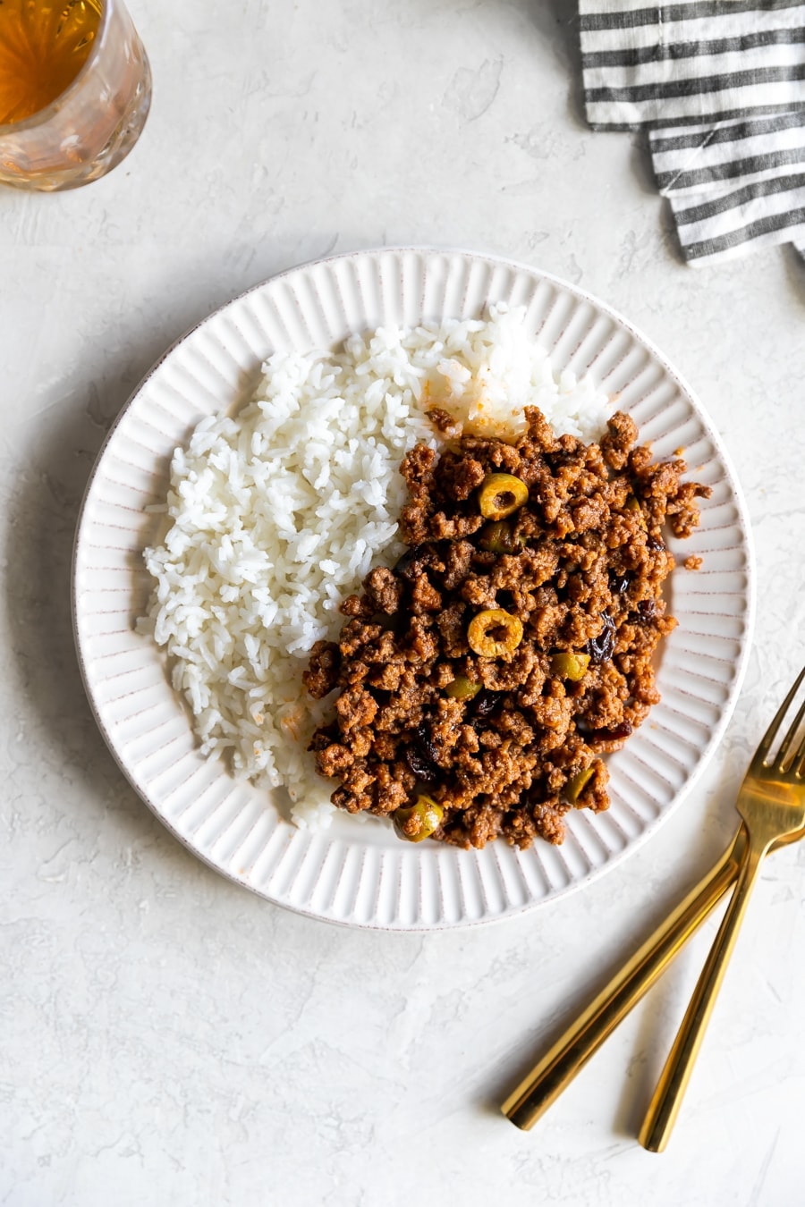 cuban picadillo served with white rice on a white plate