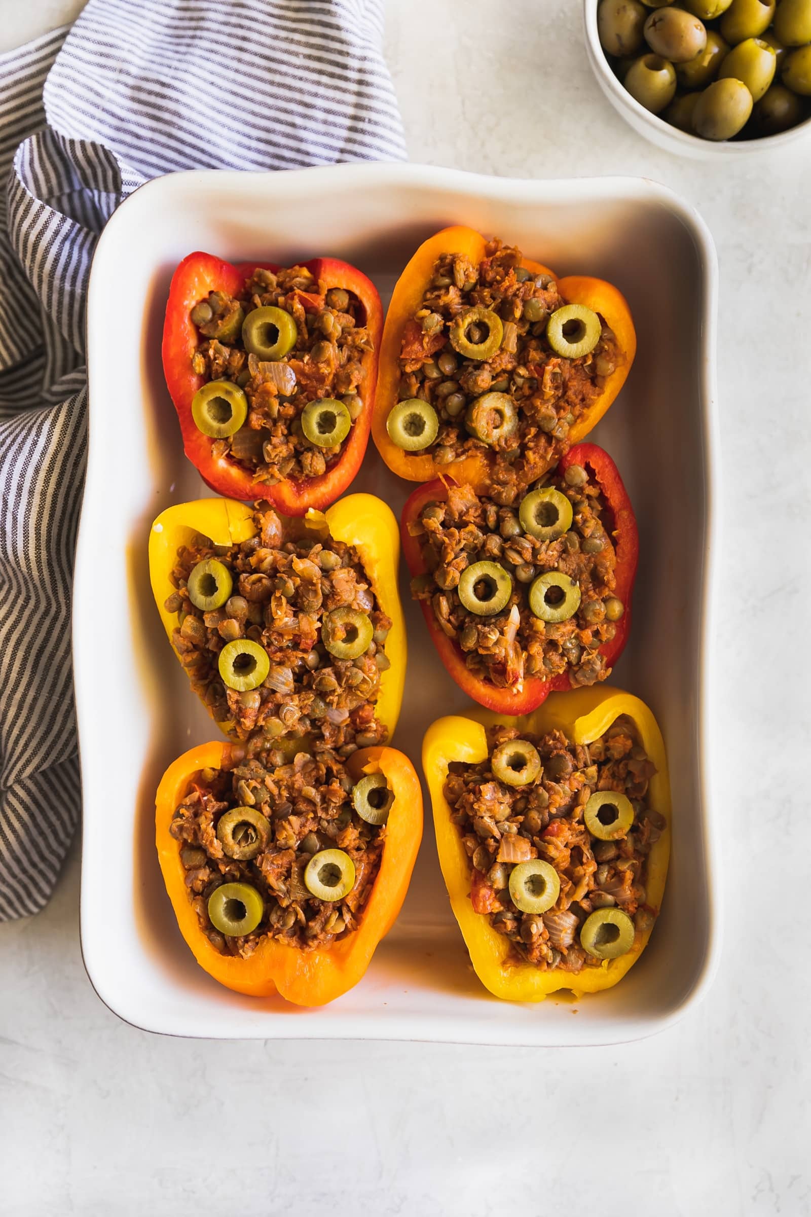 Cuban-Style Vegan Picadillo Stuffed Peppers. This vegan picadillo is a plant-based meal made Cuban-style with lentils, spices, onions, garlic, tomatoes, olives then stuffed in bell peppers. Perfect weeknight dinner!