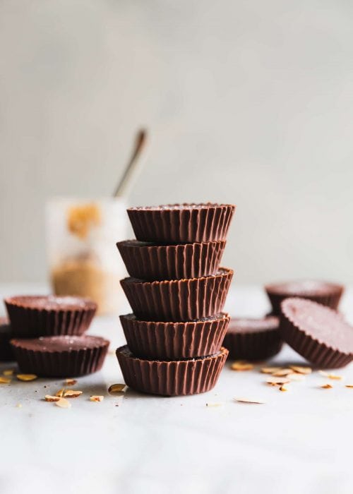 These rich and decadent almond butter cups are made with just 5 ingredients - dark chocolate, coconut oil, almond butter, chopped almonds, and sea salt. Perfect healthy-ish snack!