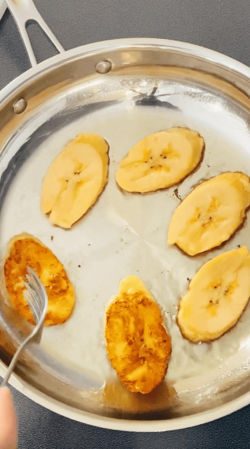 frying sweet plantains in a skillet