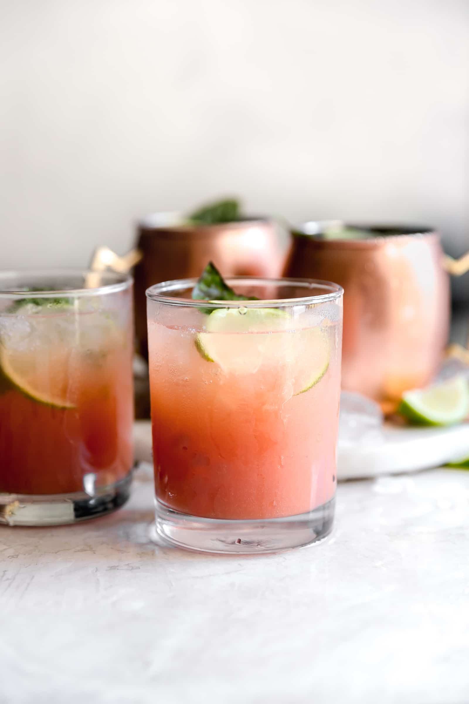 Guava Basil Moscow Mule. A twist to the traditional refreshing Vodka cocktail made with spicy ginger beer, guava nectar, fresh lime and sweet basil. Delicious drink for any time of year!