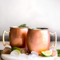 Guava Basil Moscow Mule. A twist to the traditional refreshing Vodka cocktail made with spicy ginger beer, guava nectar, fresh lime and sweet basil. Delicious drink for any time of year!