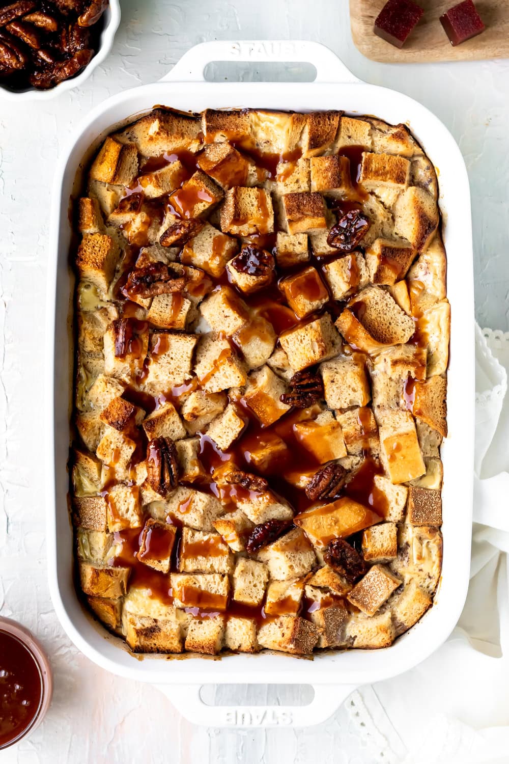 baked guava caramel bread pudding in a white baking dish