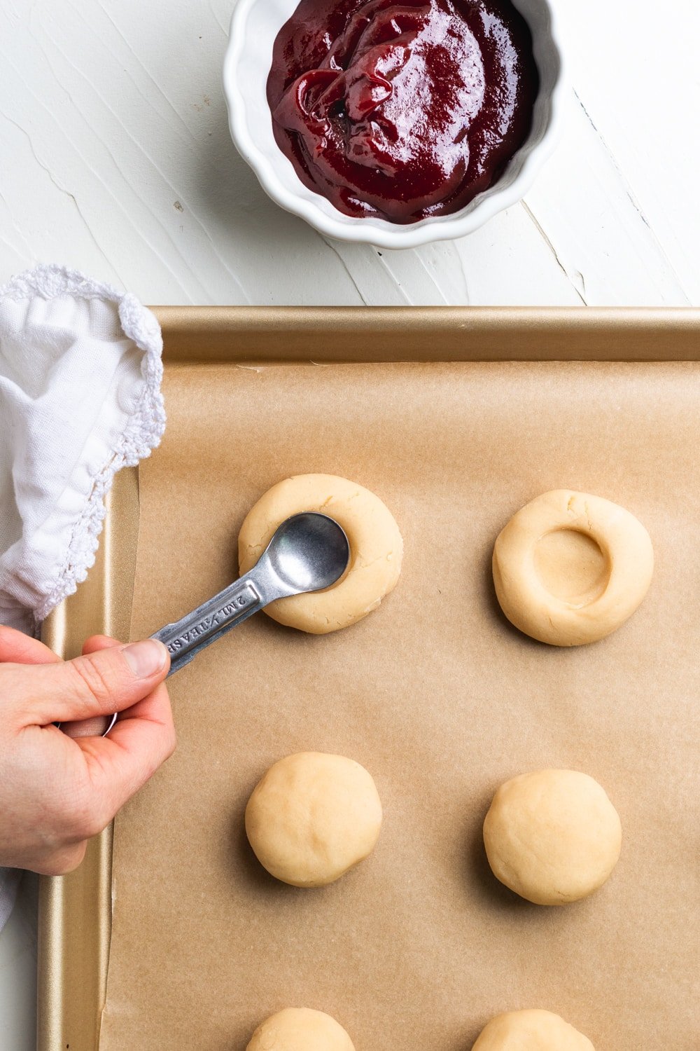 shortbread thumbprint cookies being indented