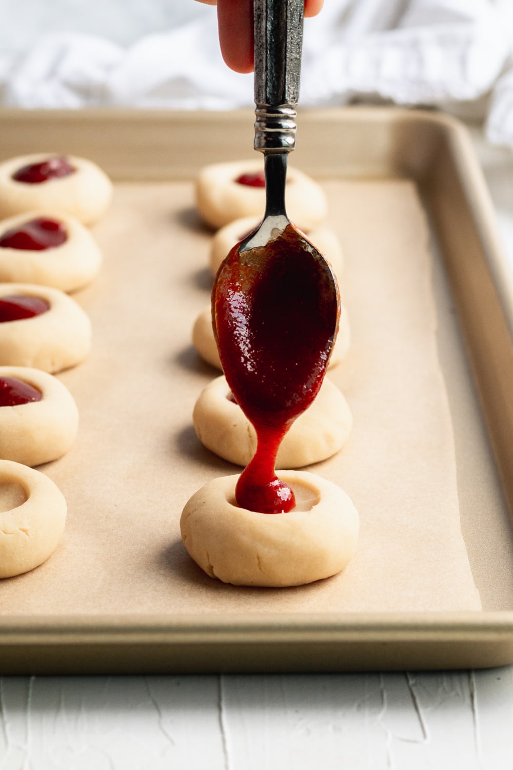 buttery thumbprint cookies being filled with guava jam