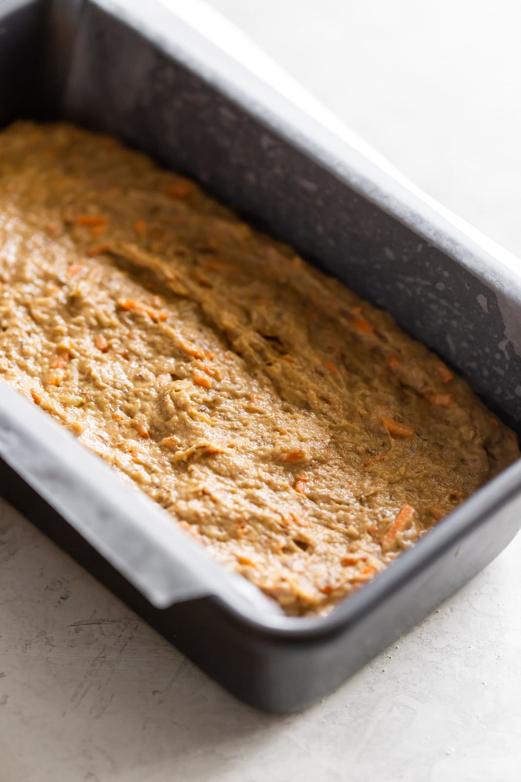 Dairy-free, refined sugar-free, moist carrot cake banana bread made with wholesome ingredients and a crunchy walnut crumble topping!