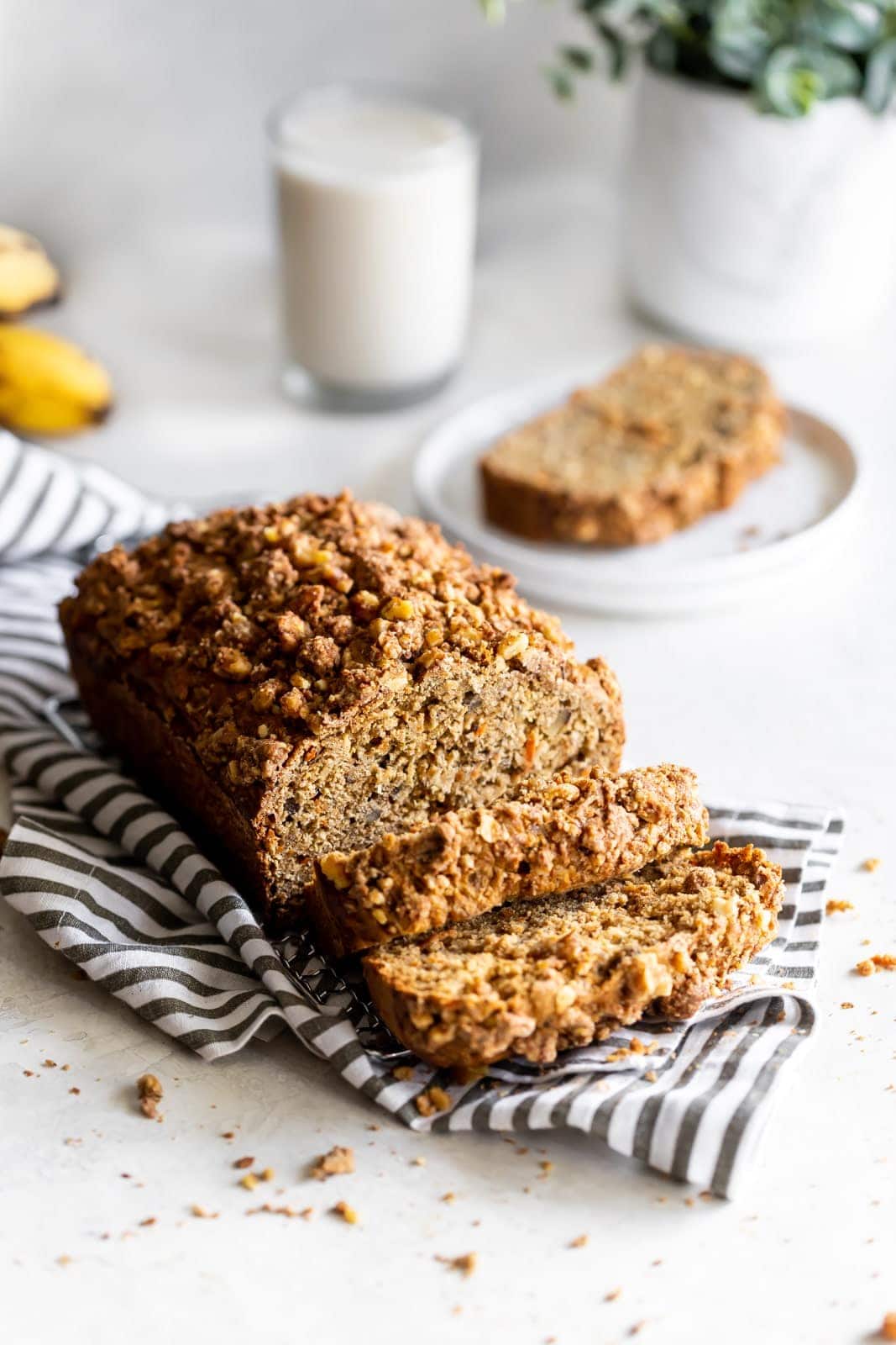 Dairy-free, refined sugar-free, moist carrot cake banana bread made with wholesome ingredients and a crunchy walnut crumble topping!