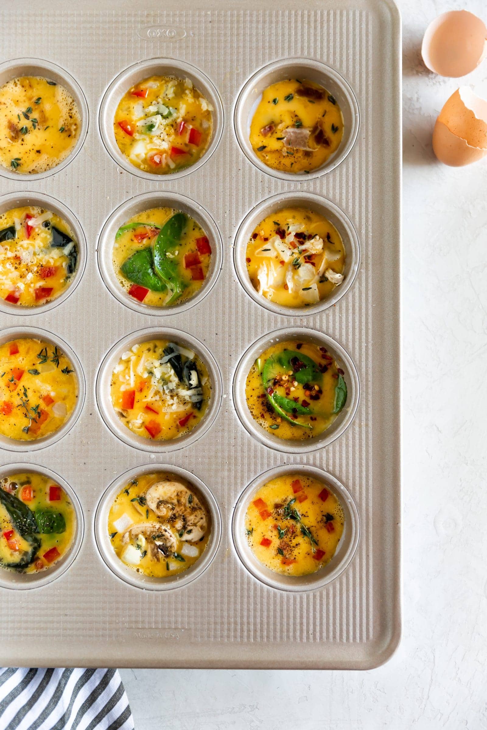 Egg muffin cups in muffin tin, ready to bake