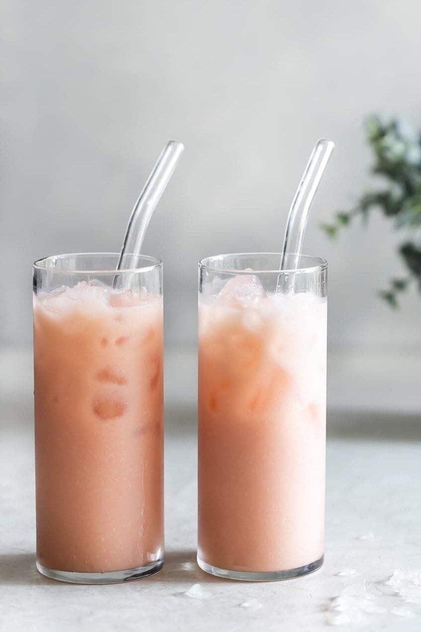 iced guava passionfruit drink in tall glasses with glass straws