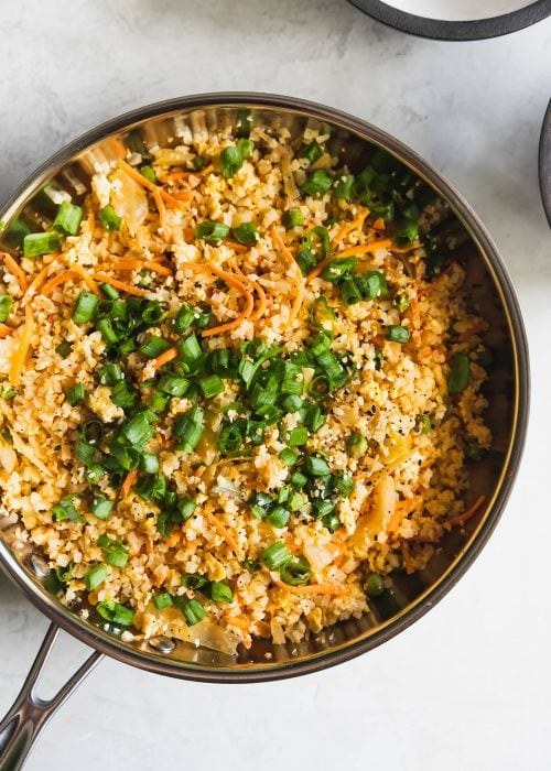 Love fried rice? Here's a healthier alternative made with riced cauliflower, peas, carrots, kimchi, garlic, soy sauce, and chili paste. Ready in just 15-minutes!