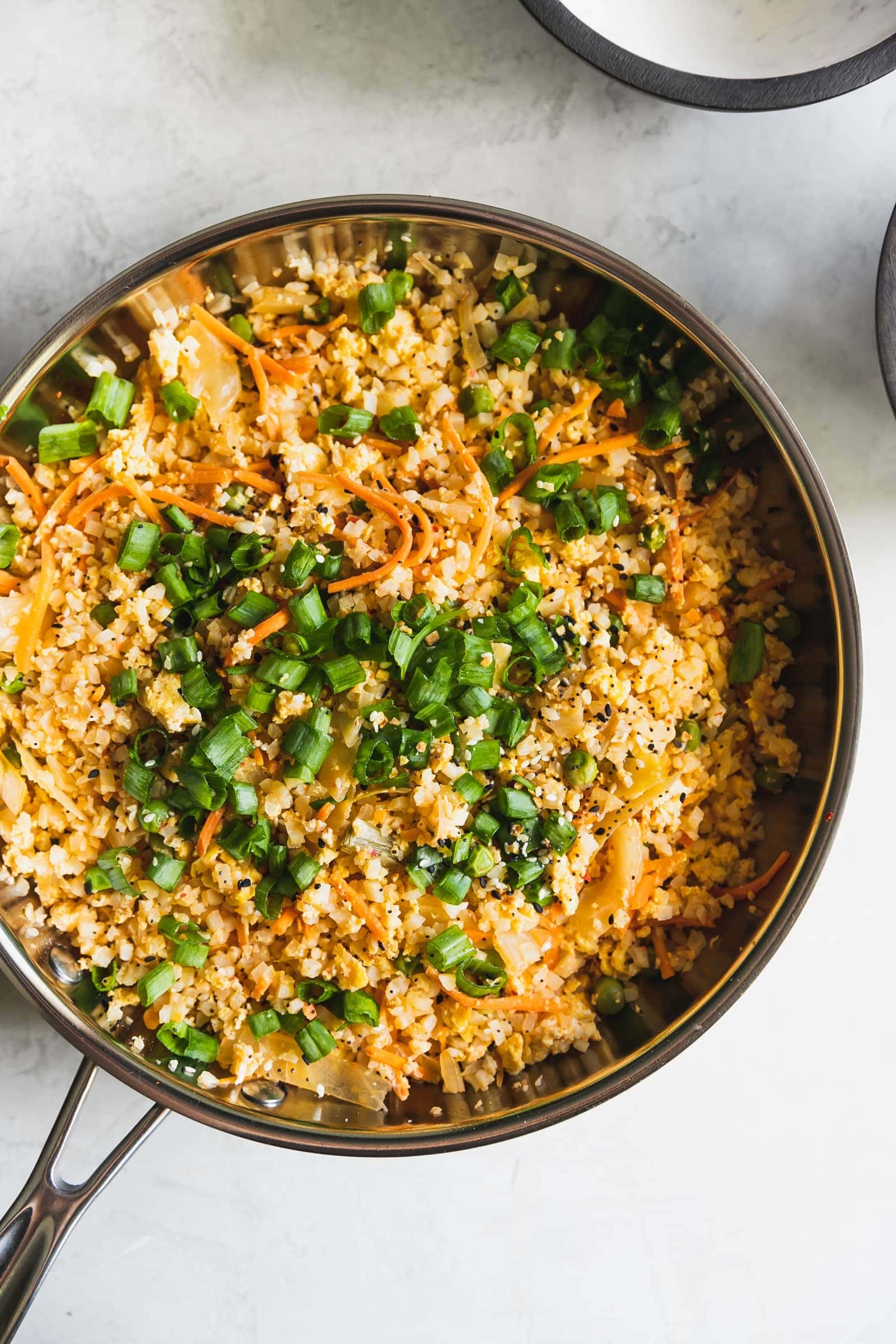 Love fried rice? Here's a healthier alternative made with riced cauliflower, peas, carrots, kimchi, garlic, soy sauce, and chili paste. Ready in just 15-minutes!