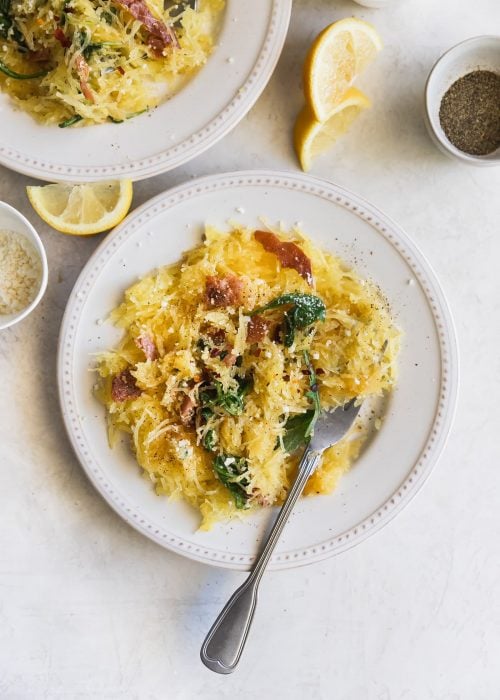 Lemony Cacio e Pepe Spaghetti Squash. A flavorful, low carb meal made with roasted spaghetti squash, lemon, arugula, pancetta, red pepper flakes, grated Parm and fresh pepper. Healthy weeknight dinner!