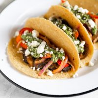vegetarian tacos with mushrooms, peppers, onions, feta cheese