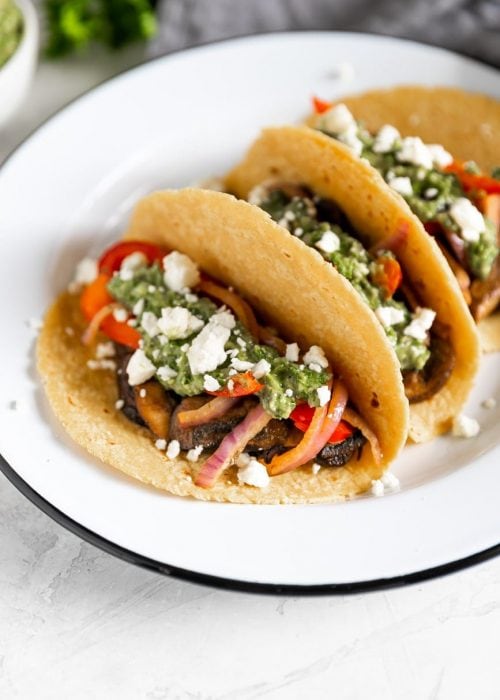 vegetarian tacos with mushrooms, peppers, onions, feta cheese