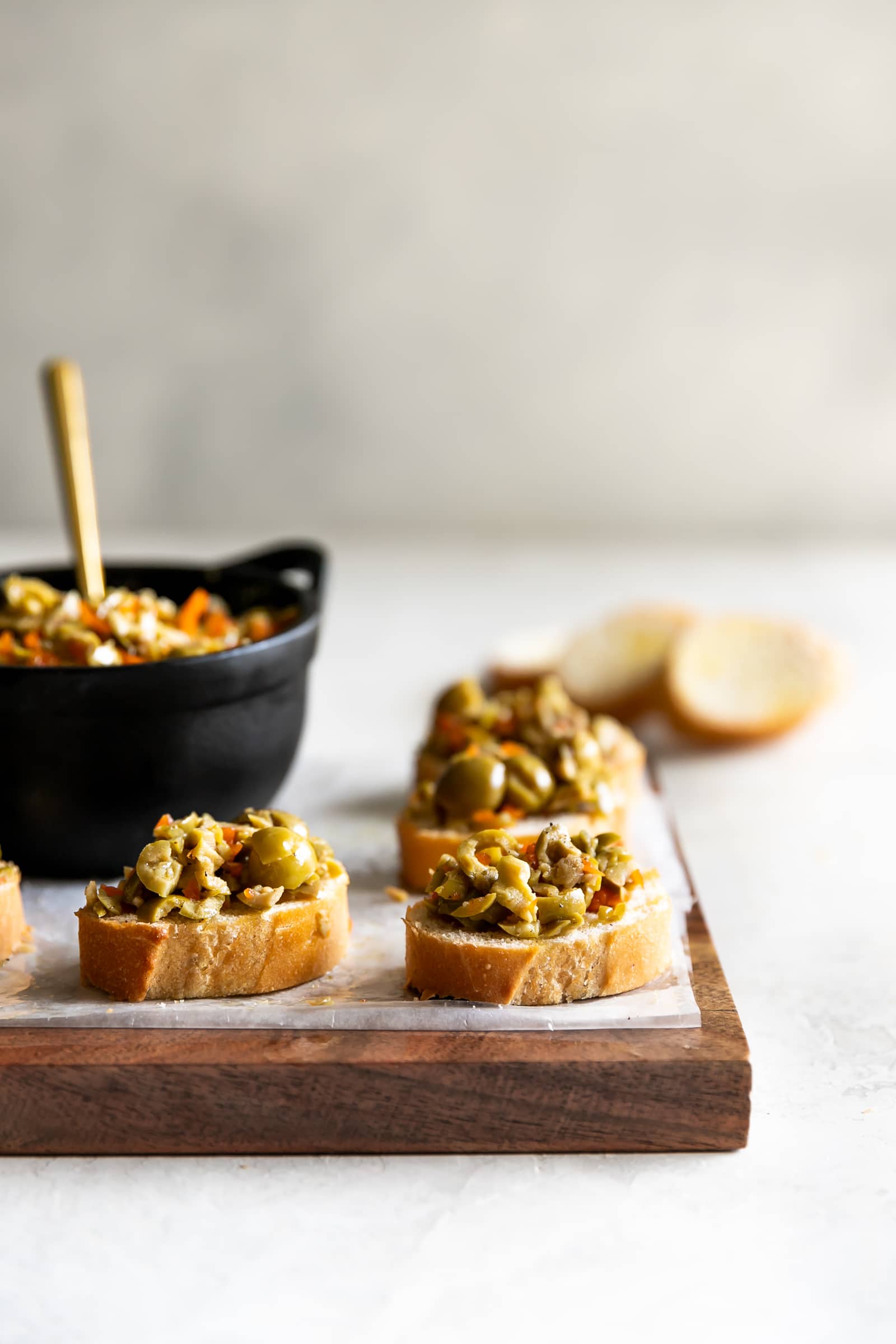 A simple yet irresistible appetizer made with tart, briny olives, capers, fresh garlic, pepper, and olive oil then served on toasted baguette slices brushed with olive oil.