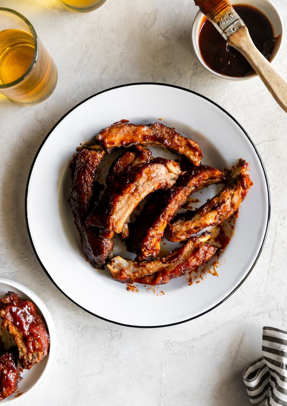 baby back ribs on a plate with bbq sauce and beer