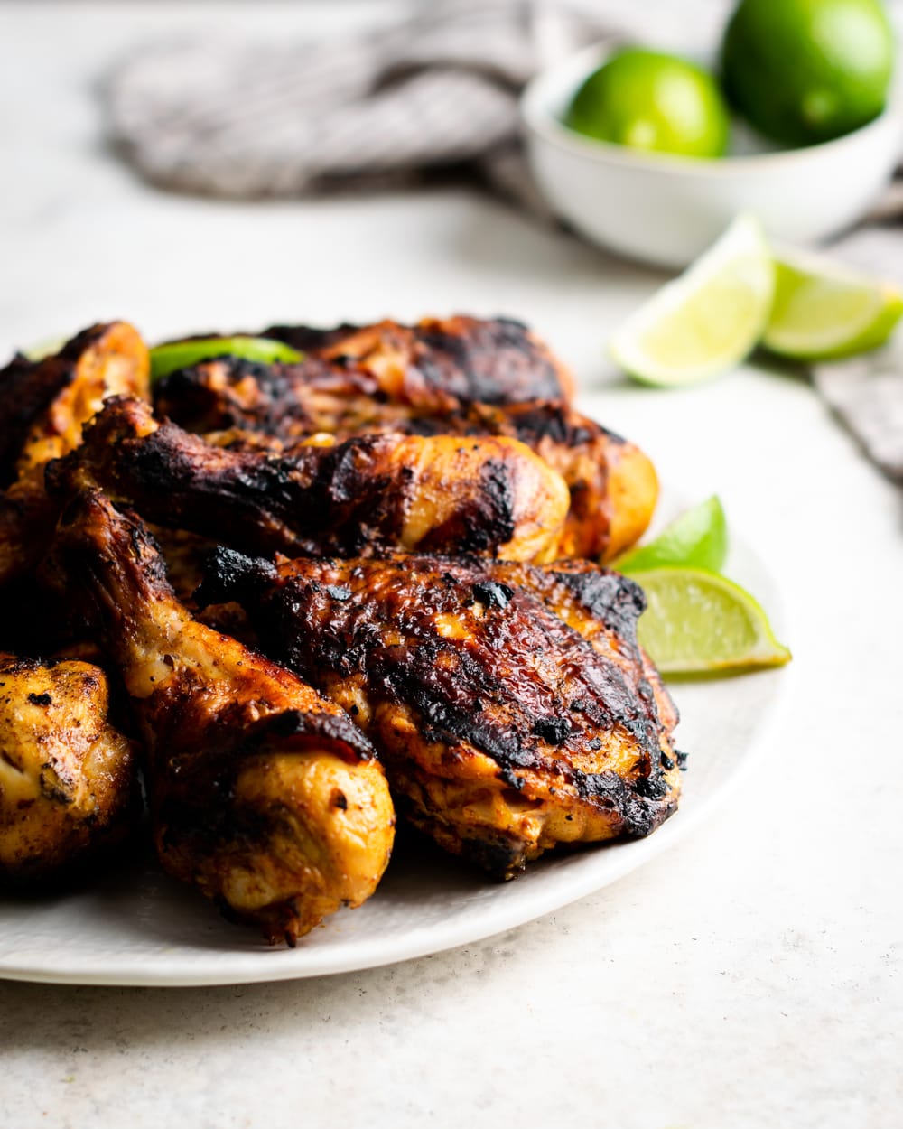 Cuban pollo asado on a plate with lime wedges