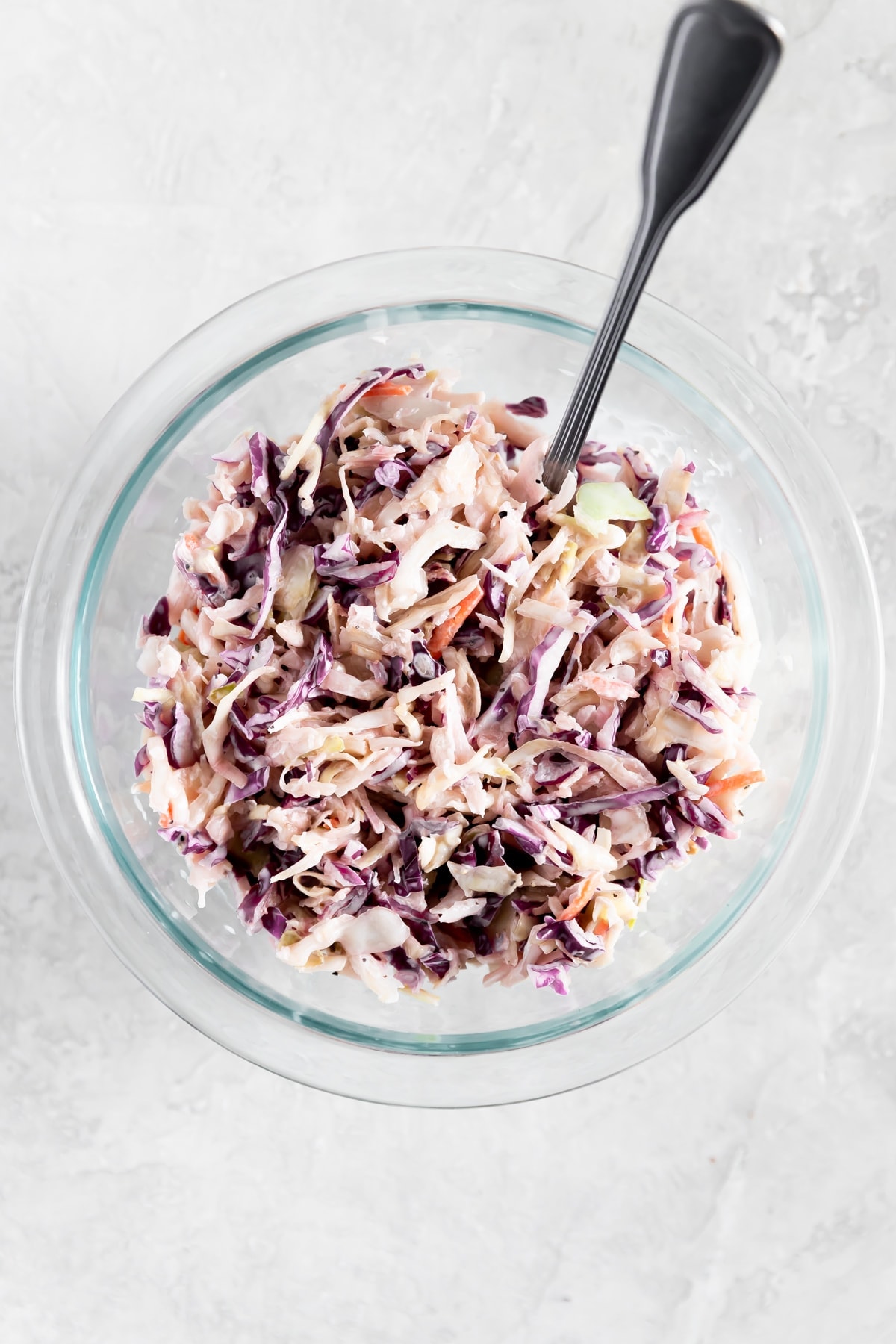 slaw for pulled pork sandwich in a bowl with a fork