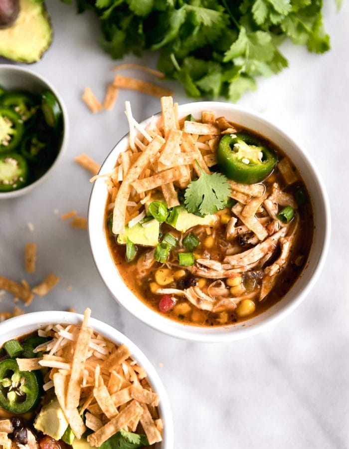A spicy, flavorful, 30-minute chicken tortilla soup made with fire roasted tomatoes, shredded chicken breast, black beans, corn, avocado and spices!