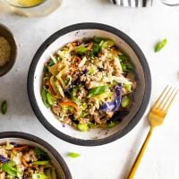 egg roll in a bowl cole slaw, ground pork, sesame oil in a bowl with a fork