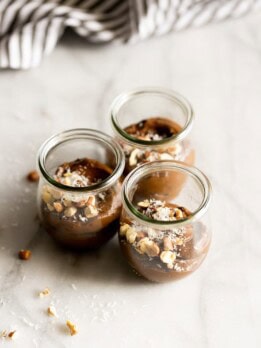 A creamy dairy-free avocado chocolate mousse made with just 5 ingredients then topped with coconut flakes and chopped hazelnuts!