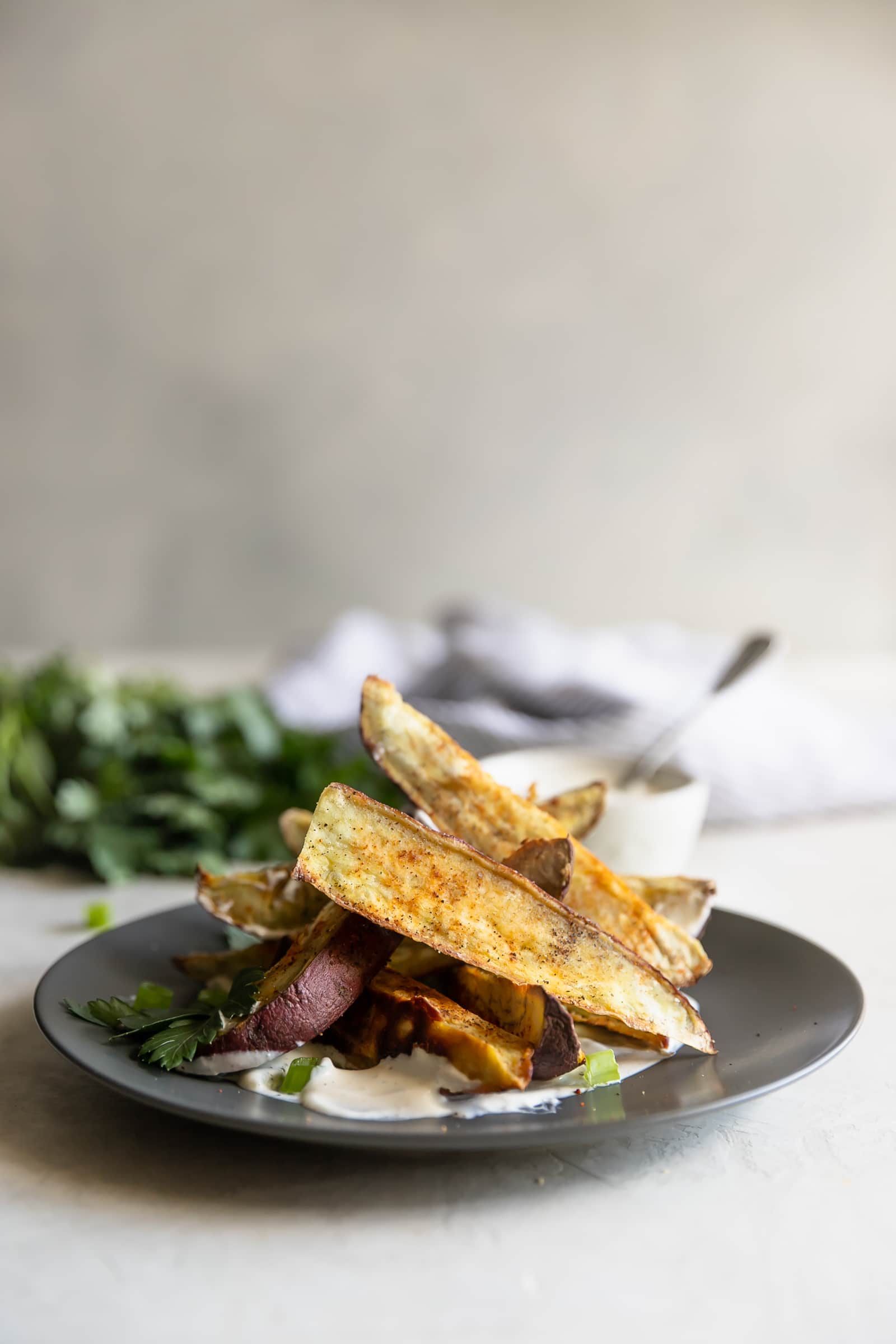 Japanese sweet potato fries, sprinkled with chili powder, salt, and pepper, roasted then served with a charred scallion creme fraiche. Perfect appetizer!