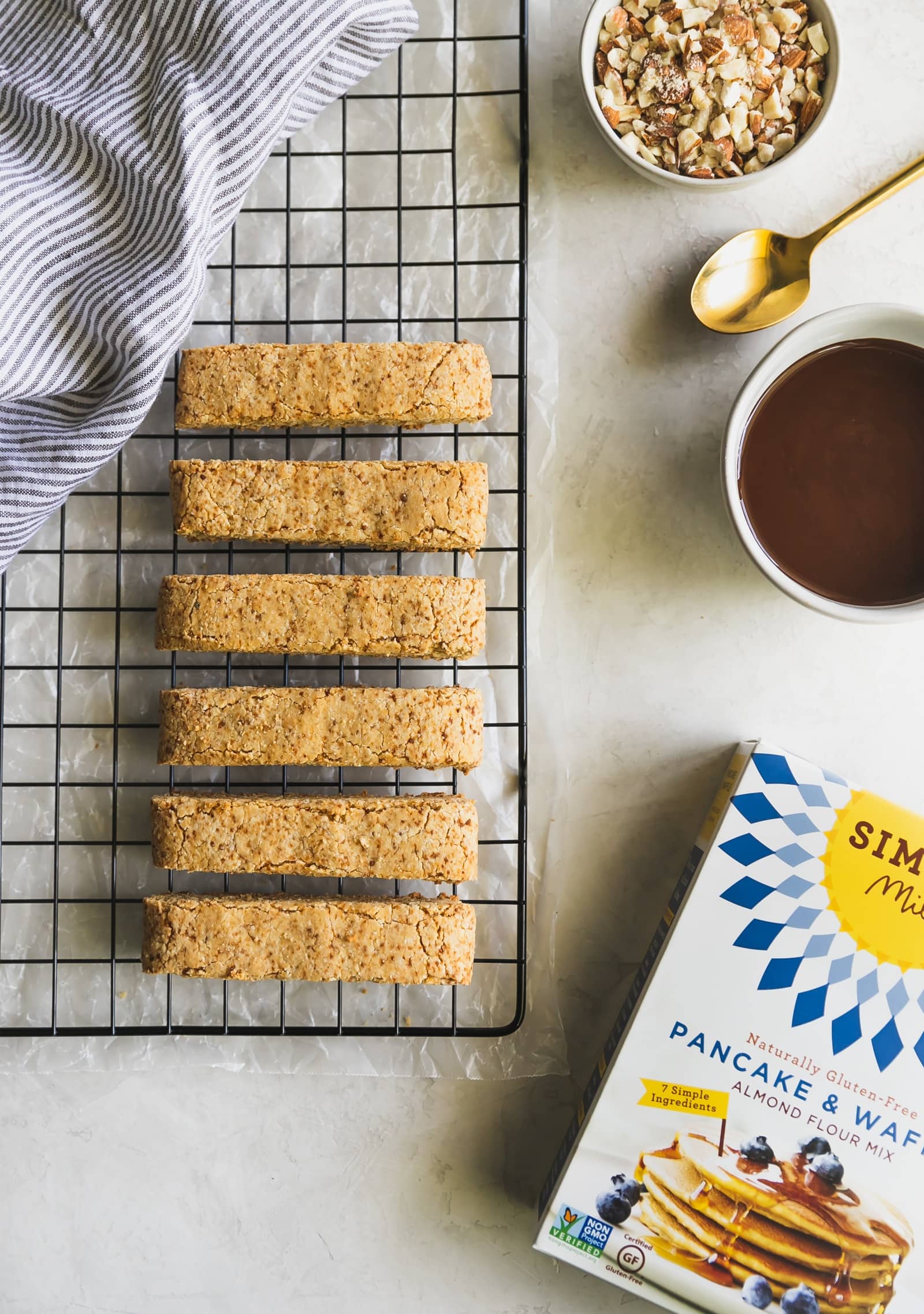 Dairy-free and grain-free almond biscotti dipped in melted dark chocolate and topped with chopped almonds. No better snack for any day of the week!