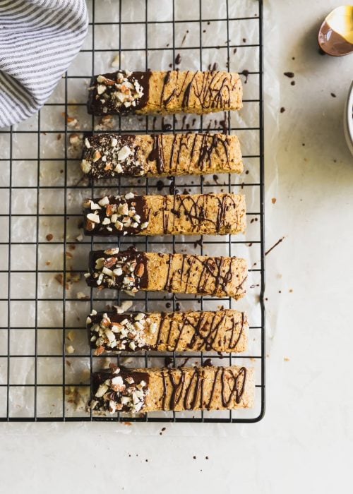 Dairy-free and grain-free almond biscotti dipped in melted dark chocolate and topped with chopped almonds. No better snack for any day of the week!