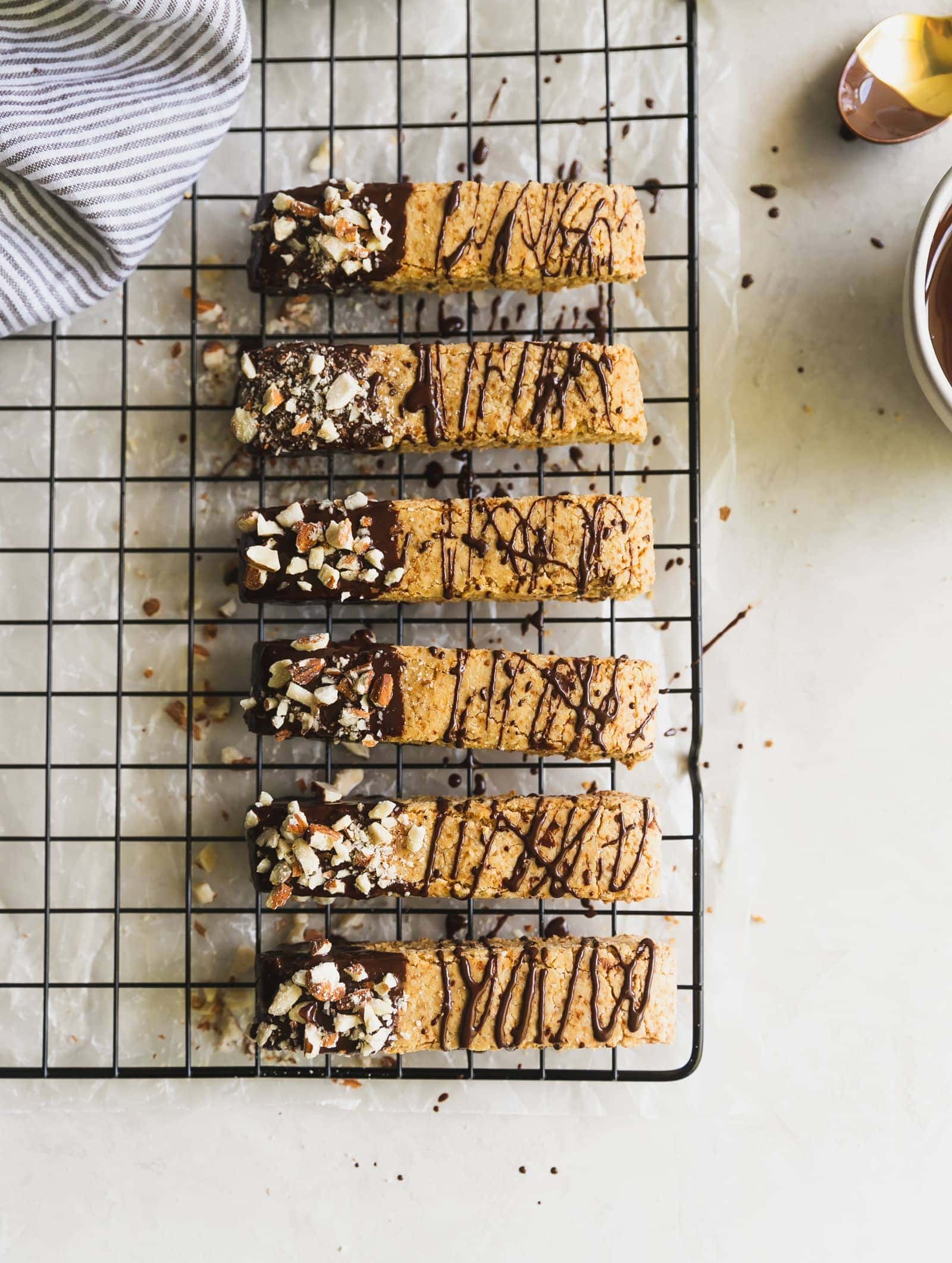 Dairy-free and grain-free almond biscotti dipped in melted dark chocolate and topped with chopped almonds. No better snack for any day of the week!