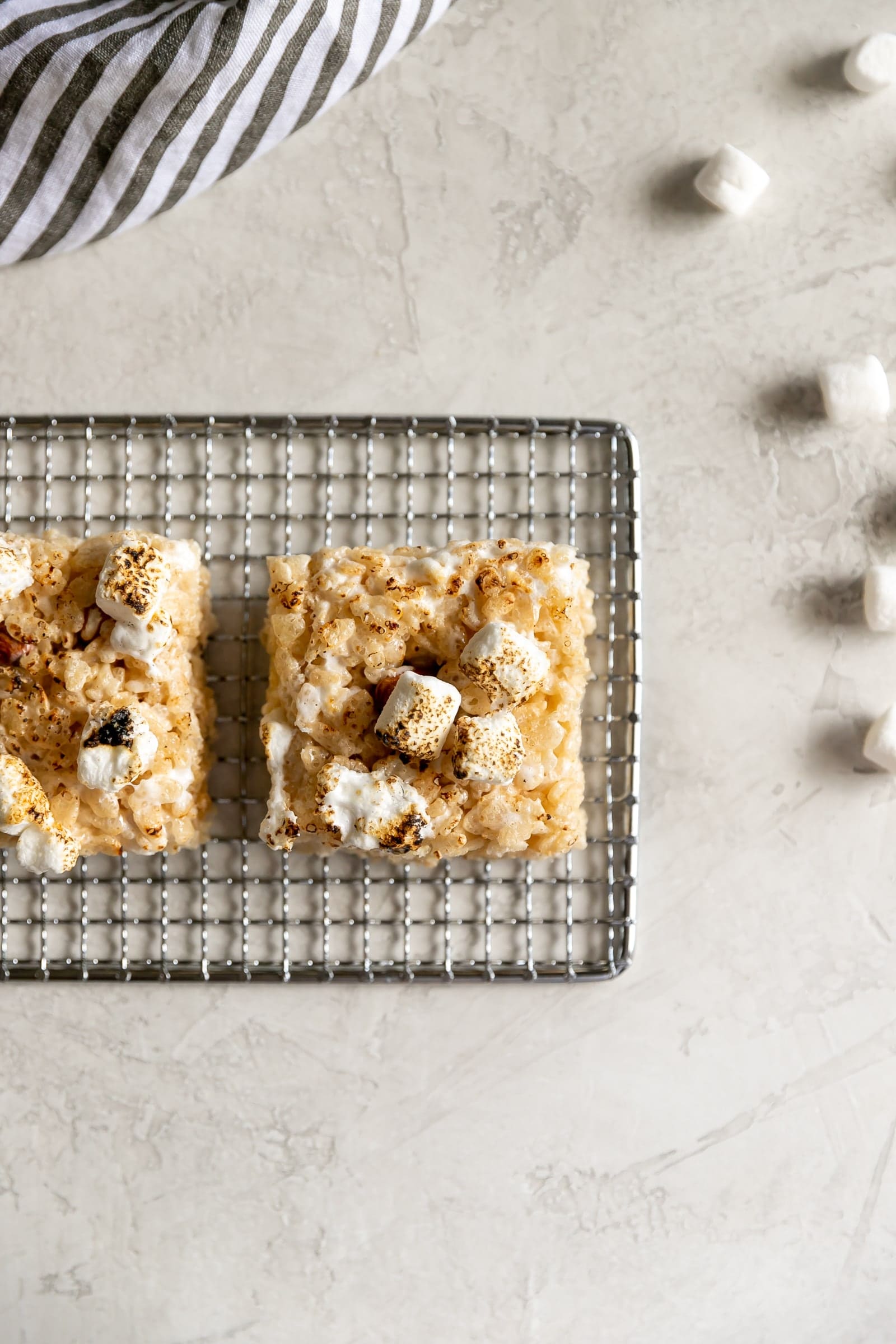 A sweet crispy classic treat with a smoky twist! Rice cereal, torched marshmallows, and smoked almonds come together to make Smoky Rice Krispie Treats.