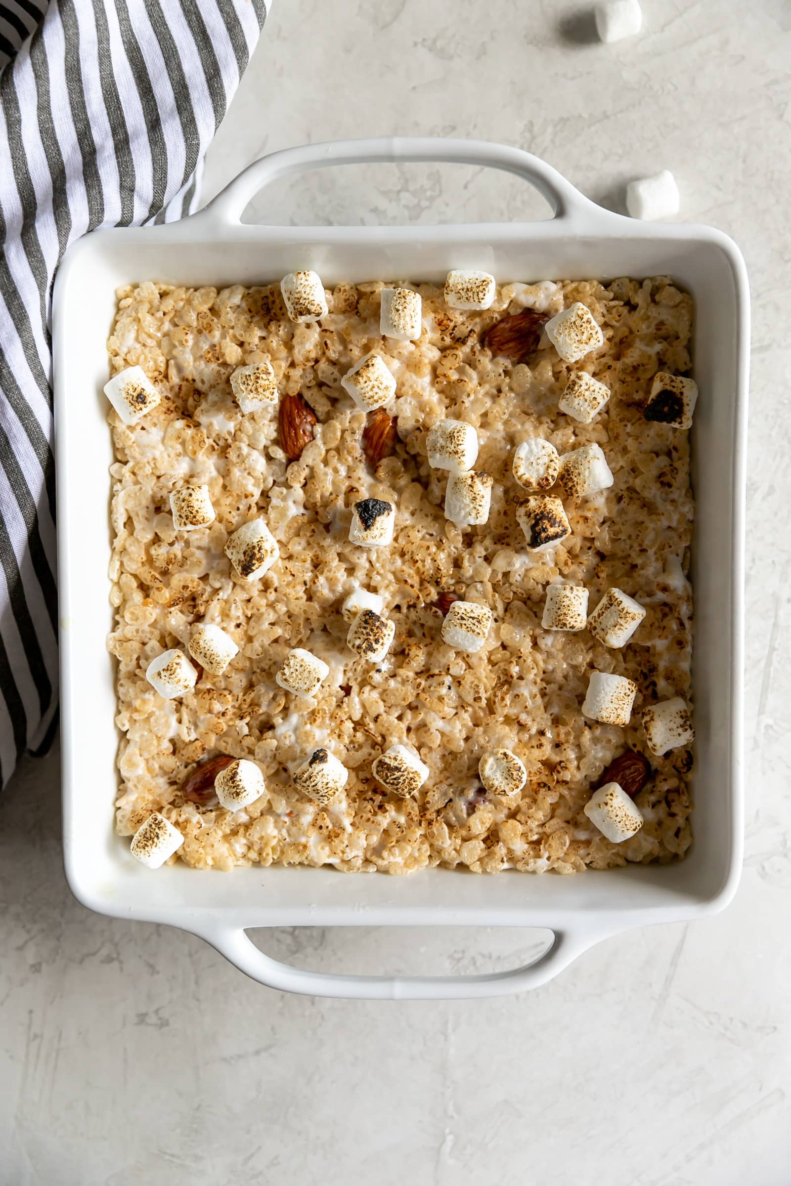 A sweet crispy classic treat with a smoky twist! Rice cereal, torched marshmallows, and smoked almonds come together to make Smoky Rice Krispie Treats.