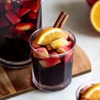 A deliciously fall-flavored red wine sangria made with pears, apples, sliced oranges and warm spices like cinnamon, ginger, and cardamom. #sangria