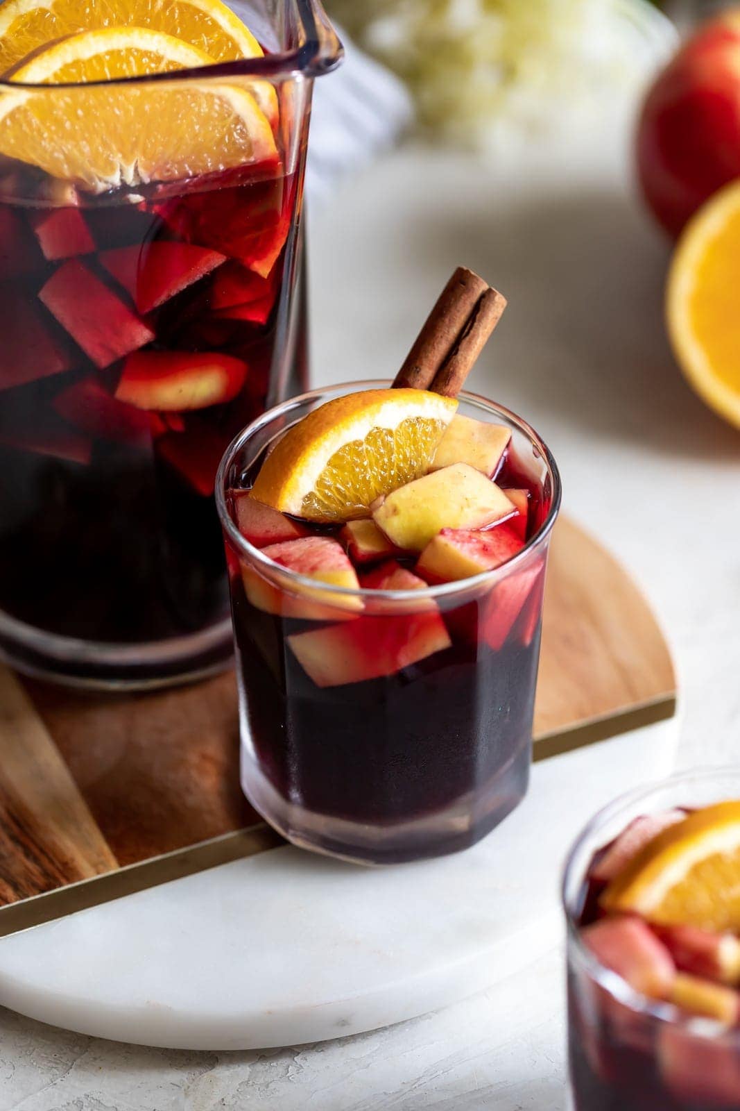 A deliciously fall-flavored red wine sangria made with pears, apples, sliced oranges and warm spices like cinnamon, ginger, and cardamom. #sangria