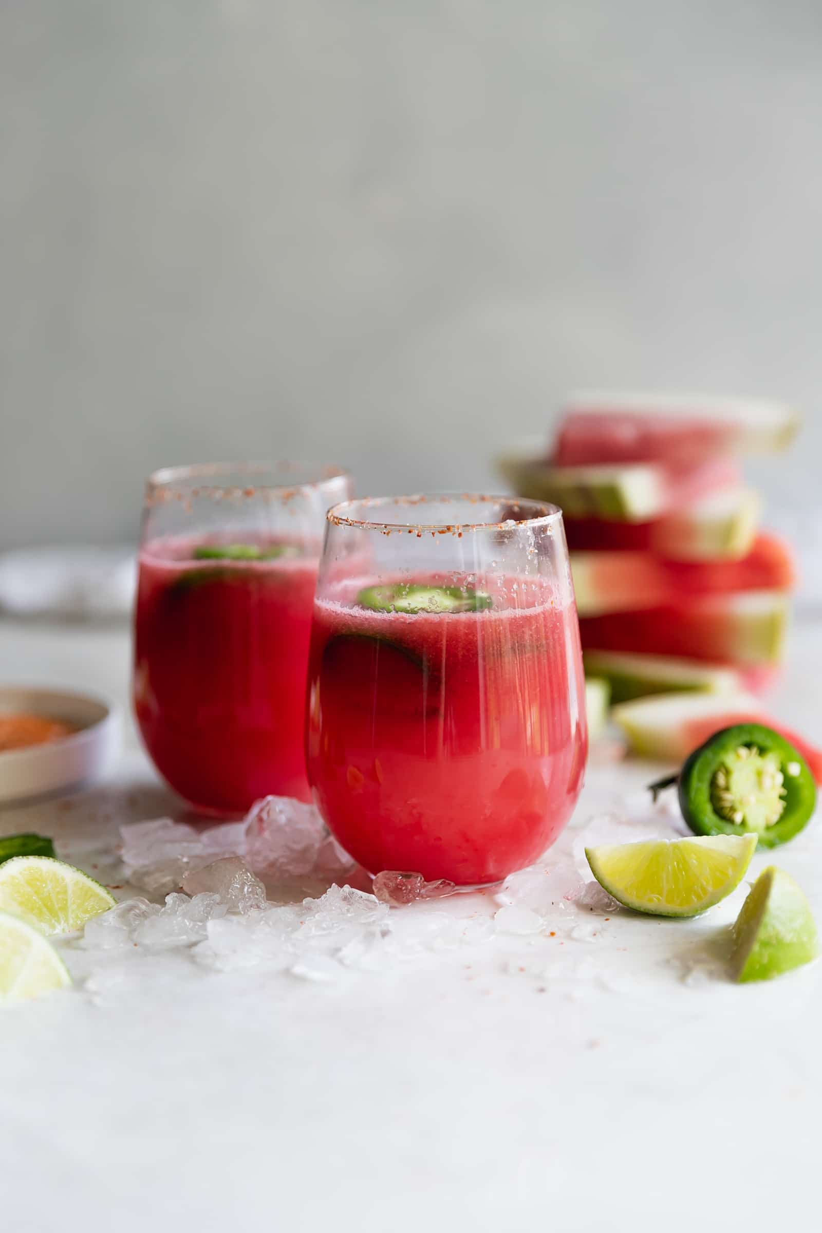 Spicy Tequila Watermelon Punch. Fresh cubed watermelon blended with tequila, lime juice, and sliced jalapeños in chili salt rimmed glasses. Refreshing drink for a hot day!