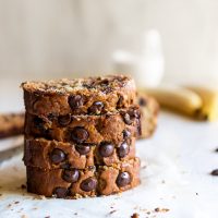 moist chocolate chip banana bread slices stacked on top of each other