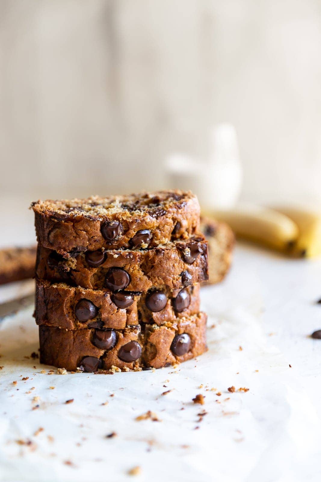 Moist chocolate chip banana bread slices stacked on top of one another