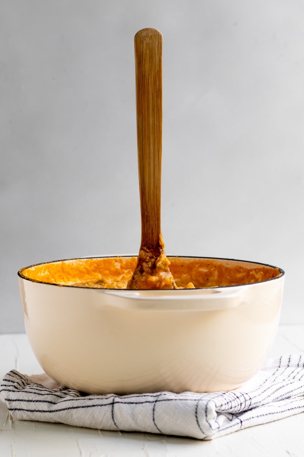 dutch oven with wooden spoon standing up in Cuban tamal stew