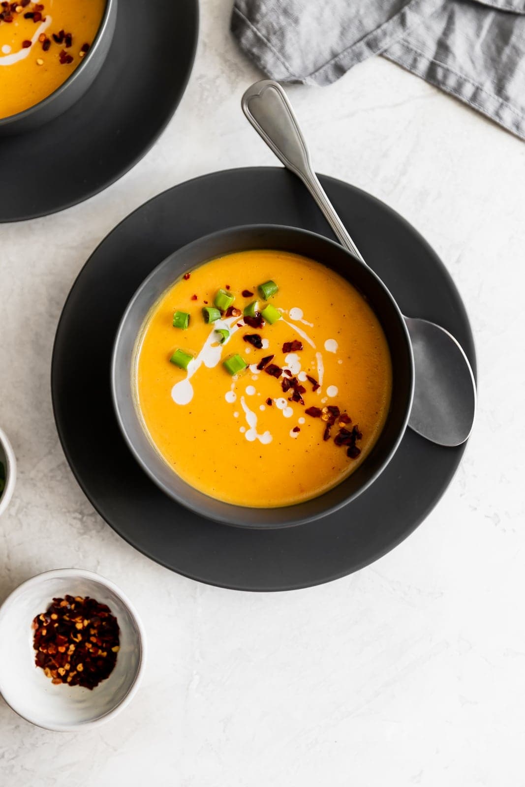 Creamy, dairy-free, and spicy vegan Thai butternut squash soup made with fresh ginger, red curry paste and coconut milk. Ready in 25 minutes!
