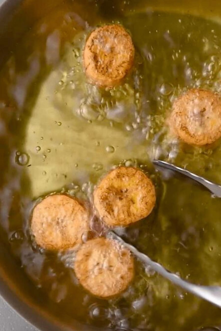 frying the tostones the first time in a skillet with oil