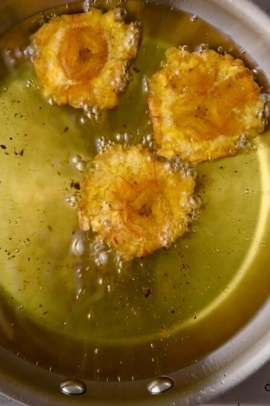 frying the tostones in a skillet with oil