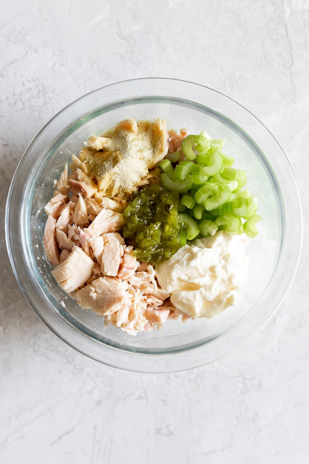 mayo, canned tuna, pickle relish, garlic powder, onion powder, salt, pepper, celery before mixing in a bowl