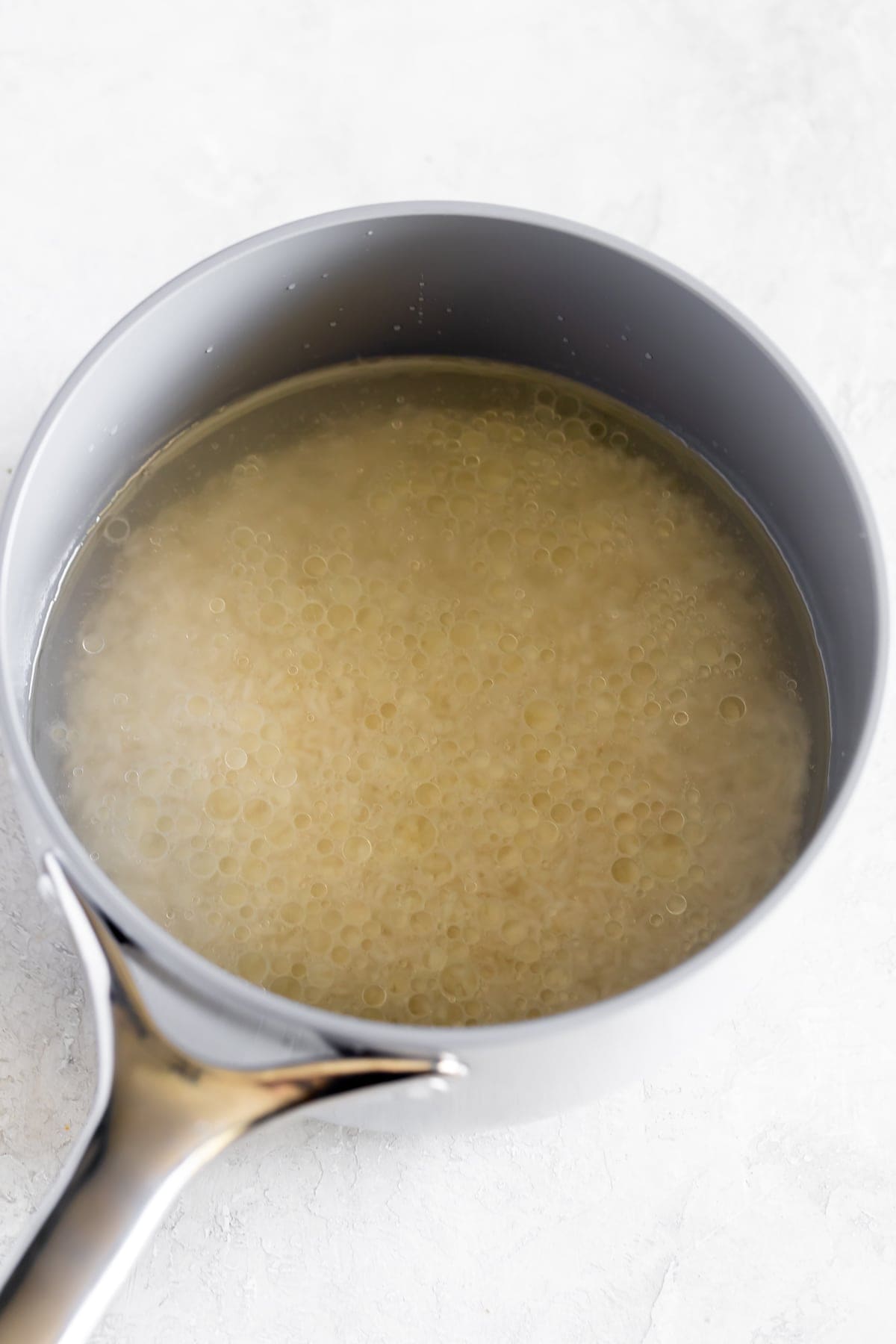rice, oil, water, salt in saucepan before cooking
