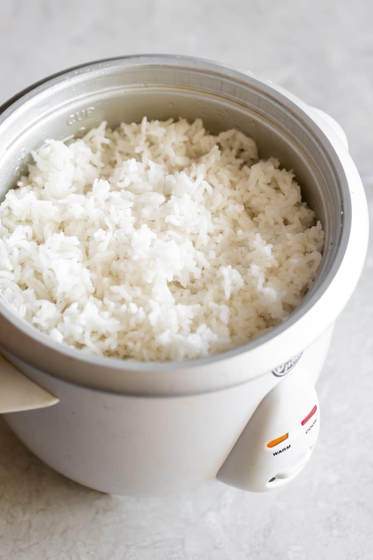 rice, oil, water, salt in rice cooker after cooking